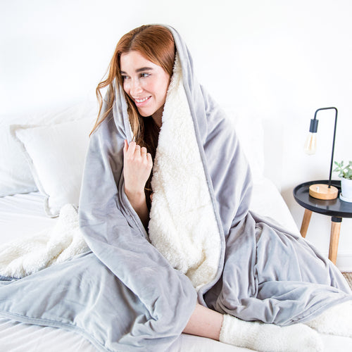 woman snuggling under weighted blanket luna winter