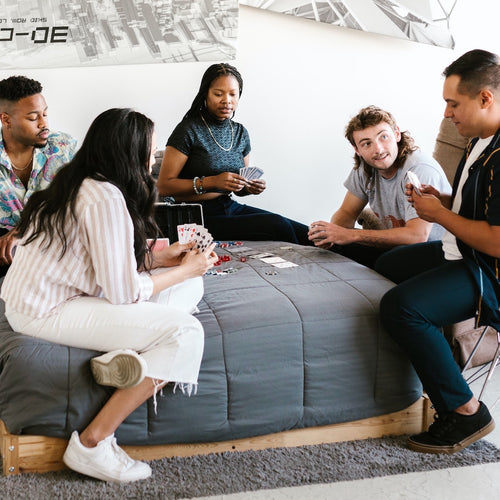 students playing cards in college dorm room